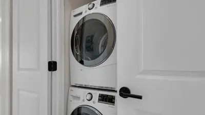 two washing machines in a kitchen next to a door at Palms C7 in Santa Rosa Beach