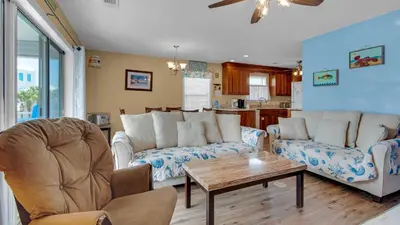a living room with two couches and a table at Beachside Villas 221 in Santa Rosa Beach