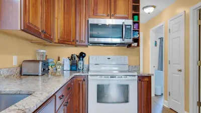 a kitchen with a white stove and a microwave at Beachside Villas 221 in Santa Rosa Beach