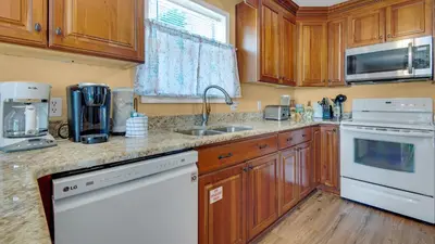 a kitchen with wooden cabinets and a white appliance at Beachside Villas 221 in Santa Rosa Beach