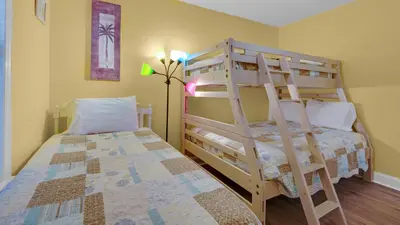 a bedroom with two bunk beds and a lamp at Beachside Villas 221 in Santa Rosa Beach