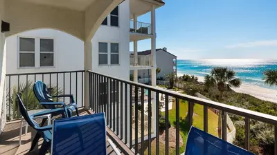 a balcony of a house with chairs and the beach at Palms C11 in Santa Rosa Beach