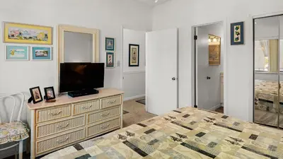 a bedroom with a bed and a television on a dresser at Palms C11 in Santa Rosa Beach