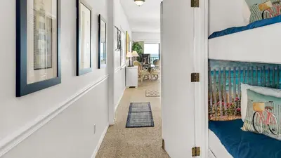 a hallway with paintings on the walls at Palms C11 in Santa Rosa Beach