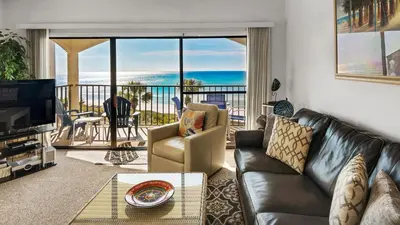 a living room with a couch and a view of the ocean at Palms C11 in Santa Rosa Beach