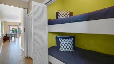 a room with two bunk beds and a hallway at Palms D7 in Santa Rosa Beach