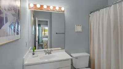 a bathroom with a sink and a toilet and a shower at Palms D7 in Santa Rosa Beach