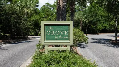 a sign that says the grove by the yard at Grateful By the Sea in Santa Rosa Beach