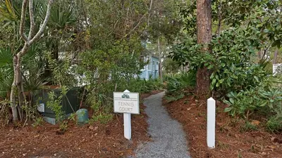 a sign that says living only in a garden at Grateful By the Sea in Santa Rosa Beach