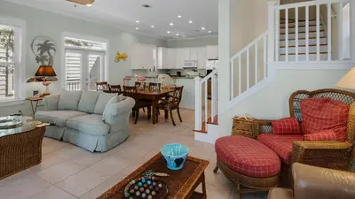 a living room with a couch and chairs and a table at Pink Flamingo in Panama City Beach
