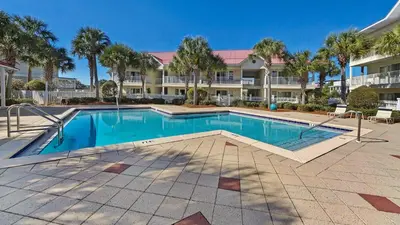 a swimming pool in front of a large building at Rollin Tide C8 in Santa Rosa Beach