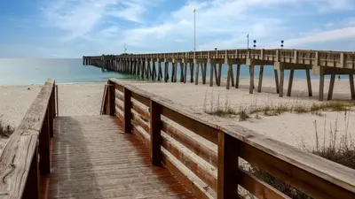 a wooden pathway to the beach with a pier at Leo's Hideaway in Panama City Beach