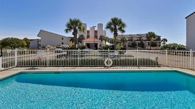 a swimming pool in front of a fence at Sago Sands 402 in Santa Rosa Beach