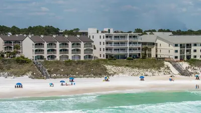 a group of people on a beach in front of a hotel at Sago Sands 402 in Santa Rosa Beach