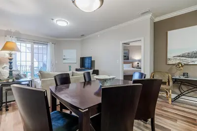 a living room with a dining room table and chairs at Village of South Walton 314D - Serenity in Rosemary Beach