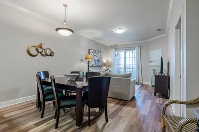 a dining room and living room with a table and chairs at Village of South Walton 314D - Serenity in Rosemary Beach