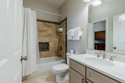 a white bathroom with a sink and a toilet and a tub at Village of South Walton 314D - Serenity in Rosemary Beach
