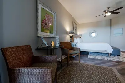 a bedroom with a bed and a desk and chairs at Village of South Walton 314D - Serenity in Rosemary Beach