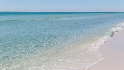 a sandy beach with the ocean in the background at Village of South Walton 314D - Serenity in Rosemary Beach