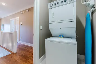 a kitchen with a washer and dryer in a room at Lifeguard Loop in Rosemary Beach