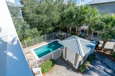 an overhead view of a swimming pool with an umbrella at Lifeguard Loop in Rosemary Beach