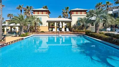 a large swimming pool in front of a house at Lifeguard Loop in Rosemary Beach