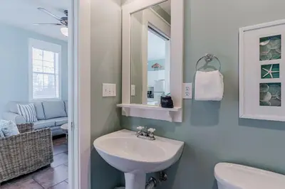 a bathroom with a sink and a mirror at Salty Paws Bungalow in Santa Rosa Beach