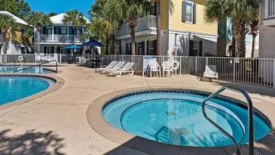 a swimming pool in front of a house at Salty Paws Bungalow in Santa Rosa Beach
