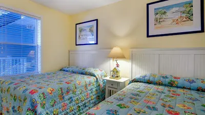 a bedroom with two beds and a window at Beachside Villas 921 in Santa Rosa Beach