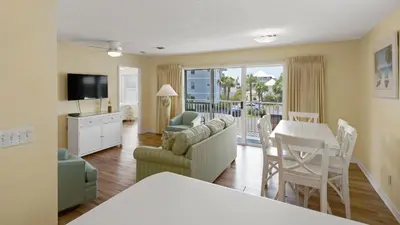 a living room with a table and a dining room at Beachside Villas 921 in Santa Rosa Beach