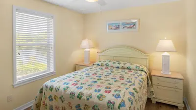 a bedroom with a bed and two lamps and a window at Beachside Villas 921 in Santa Rosa Beach