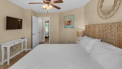 a bedroom with a large bed with a ceiling fan at Beachside Villas 1122 in Santa Rosa Beach