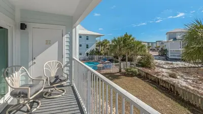 a balcony with a chair and a view of the ocean at Beachside Villas 1122 in Santa Rosa Beach