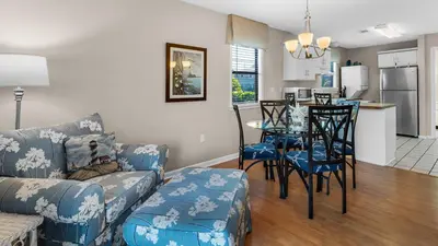 a living room with a couch and a table and a kitchen at Beachwood Villas 3A in Santa Rosa Beach