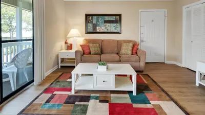 a living room with a couch and a table at Beachwood Villas 3H in Santa Rosa Beach