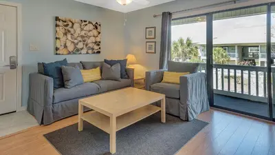 a living room with a couch and two chairs and a table at Beachwood Villas 7F in Santa Rosa Beach