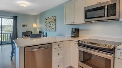 a kitchen with white cabinets and a microwave at Beachwood Villas 7F in Santa Rosa Beach