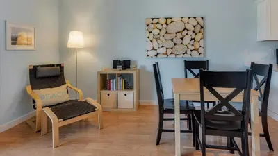 a living room with two chairs and a table and a picture at Beachwood Villas 7F in Santa Rosa Beach