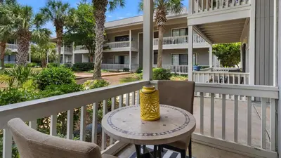 a yellow vase sitting on a table on a balcony at Beachwood Villas 4C in Santa Rosa Beach