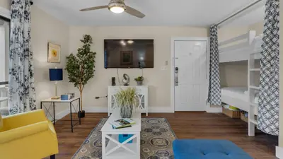 a living room with a couch and a bunk bed at Beachwood Villas 4C in Santa Rosa Beach
