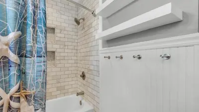 a bathroom with a shower curtain and a toilet at Beachwood Villas 8D in Santa Rosa Beach