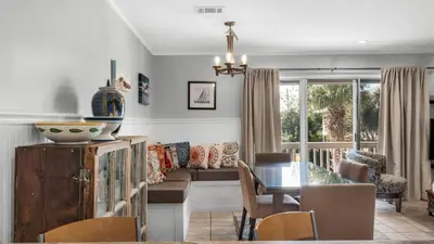 a living room with a table and a dining room at Beachwood Villas 8D in Santa Rosa Beach