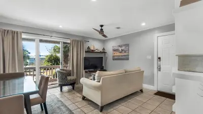 a living room with a couch and a table at Beachwood Villas 8D in Santa Rosa Beach
