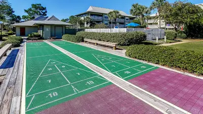 a painted football field with a bench and a house at Beachwood Villas 9B in Santa Rosa Beach