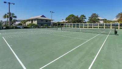 a tennis court with a person standing on it at Beachwood Villas 13A in Santa Rosa Beach