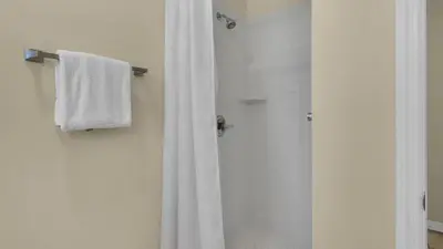 a bathroom with a shower with a white shower curtain at Beachwood Villas 13A in Santa Rosa Beach