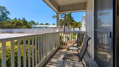 two chairs sitting on the porch of a house at Beachwood Villas 13A in Santa Rosa Beach