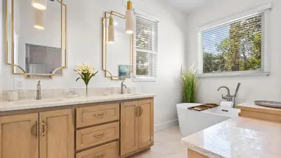 a bathroom with two sinks and a tub and a toilet at Crow's Nest in Santa Rosa Beach