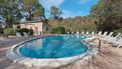 a swimming pool with lounge chairs around it at Crow's Nest in Santa Rosa Beach
