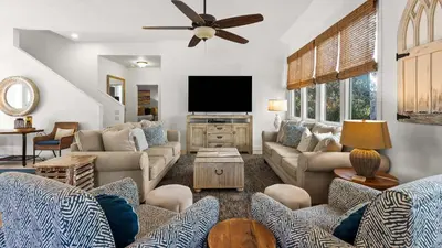 a living room with couches and a flat screen tv at Crow's Nest in Santa Rosa Beach